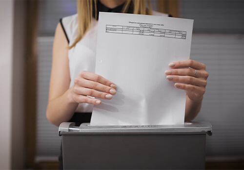 Woman Shredding Sensitive Documents